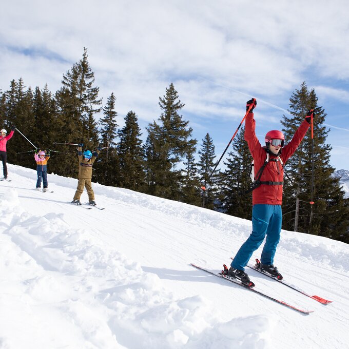 Family and friends enjoying skiing in the mountains.