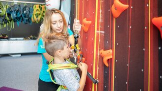 A child is being secured for climbing.