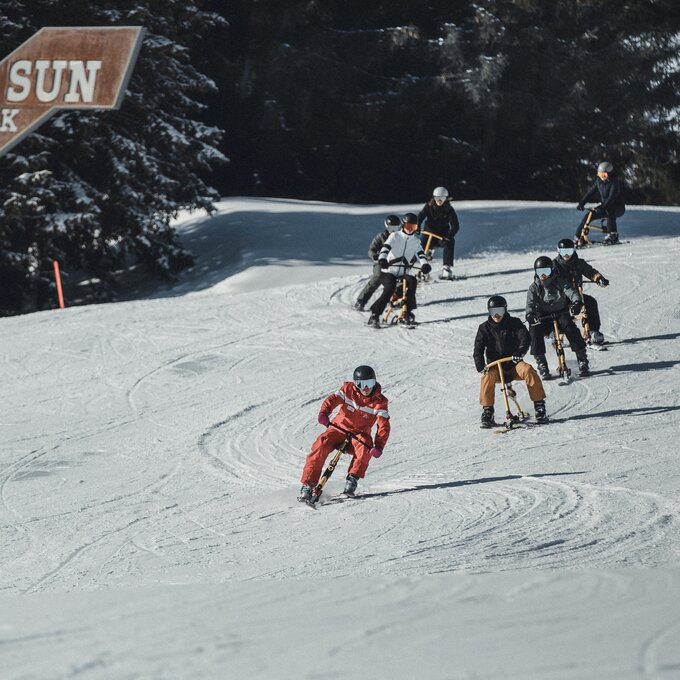 Riders on snow with sleds at Sun Park.