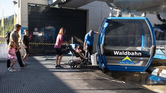 Family and others waiting for the Waldbahn gondola.