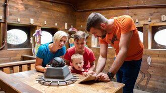 Family solving a riddle in an escape room.