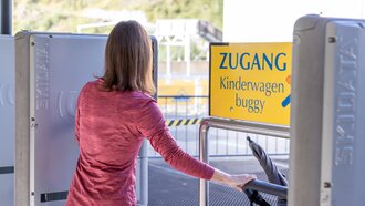 Woman with stroller at the buggy access.