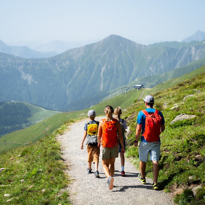 A group of hikers with backpacks enjoying the mountain views.