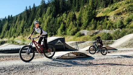 Young bikers riding in a bike park.