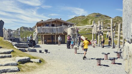 Families and children enjoying a playground in the mountains.