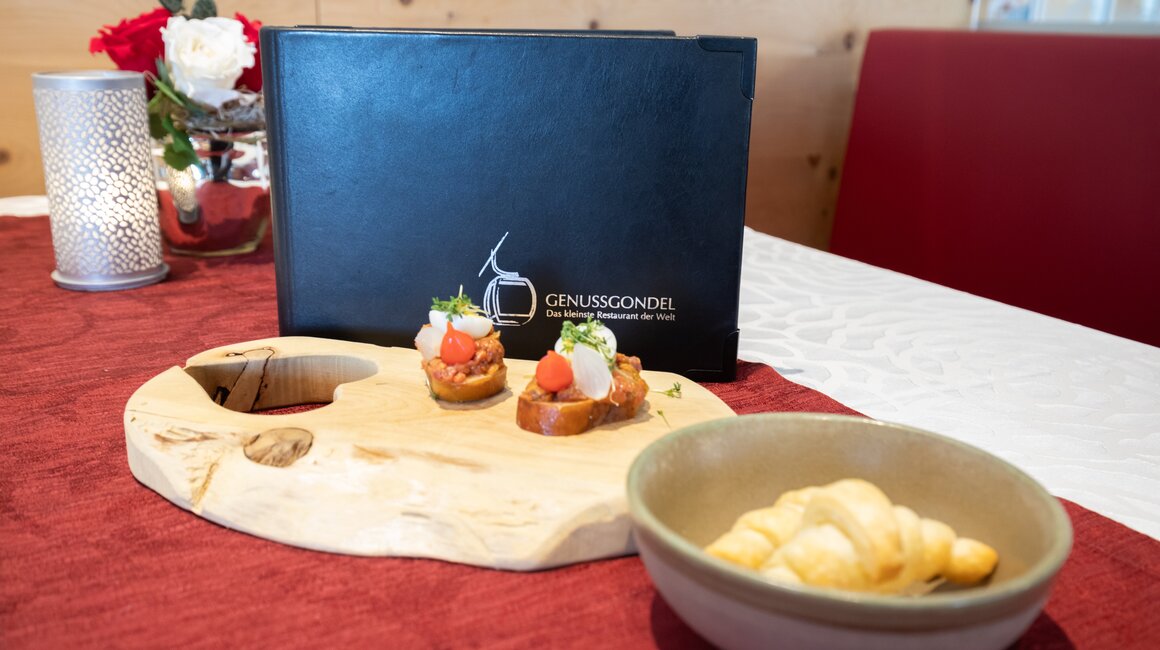 Ein Tisch im Restaurant mit einer Speisekarte und Appetizern.