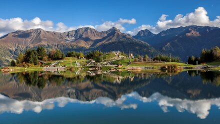 Scenic view of mountains reflected in calm water
