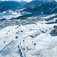 Aerial view of a snowy village in the Alps.