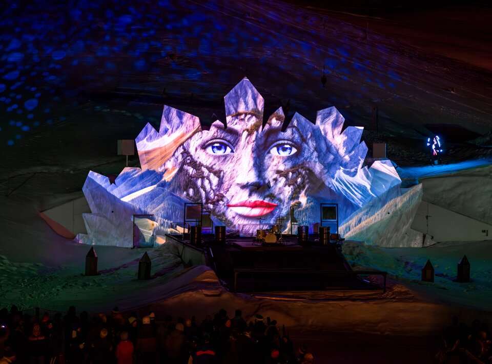 Impressive light projection of a face on an ice structure.