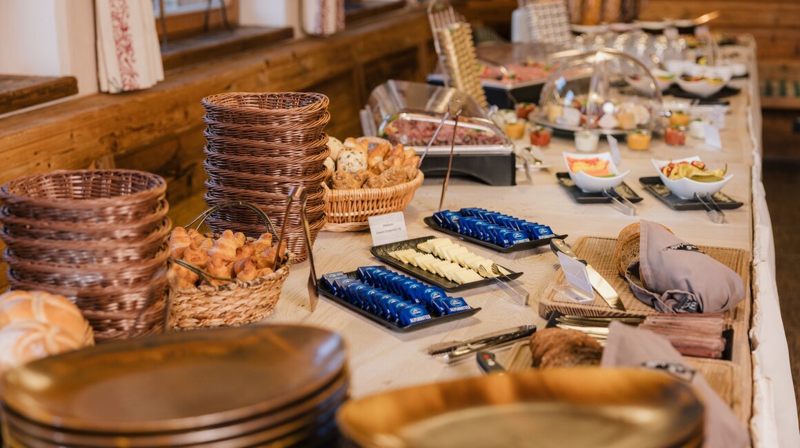 A rich breakfast buffet with pastries, fruits, and dairy products.