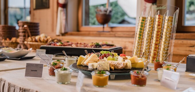 Variety of cheese buffet with various dips and bread.