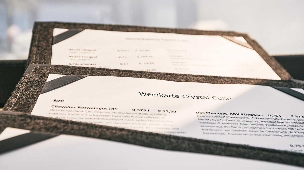 Close-up view of the wine menu featuring red wines and prices.