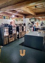 Interior view of a fashion store with shelves and clothing.