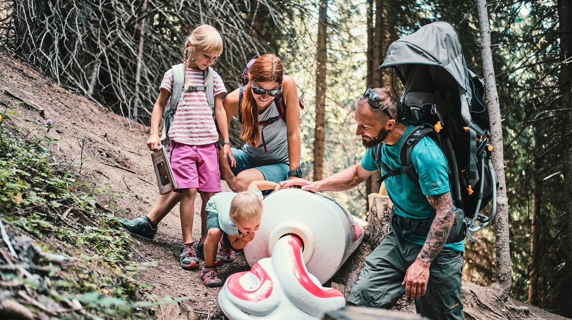 A family explores nature while assisting a child.